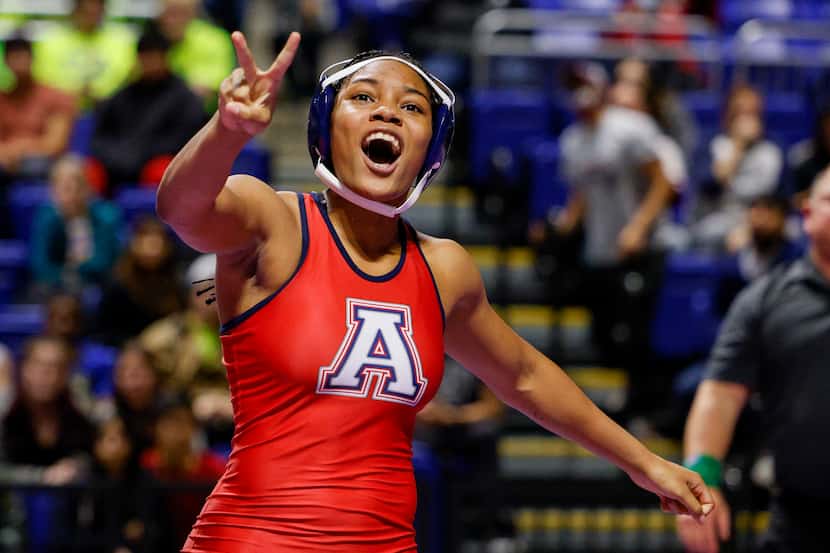 Jasmine Robinson of Allen holds up two fingers after winning the championship match of the...