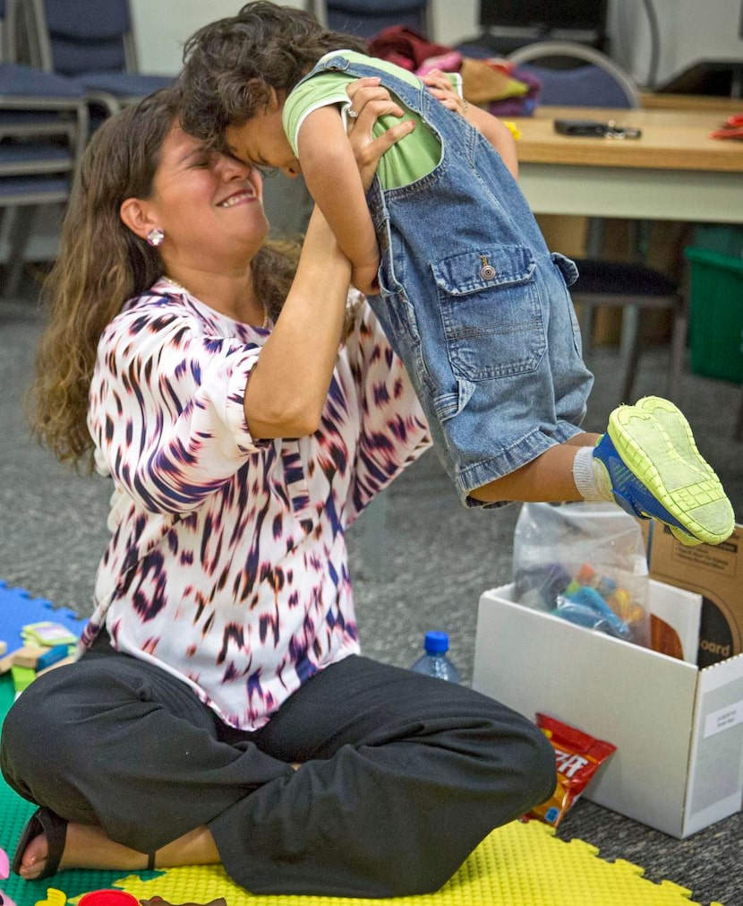 
Alex Perez (left) plays  with her son, Nicolas Perez.
