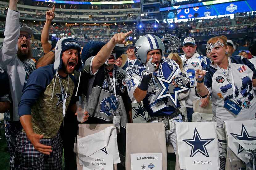 Dallas Cowboys fans pose for a TV camera at the first round of the NFL draft at AT&T Stadium...