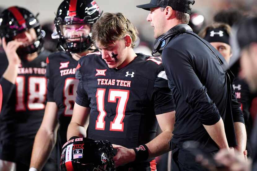 Texas Tech's Jake Strong (17) speaks with offensive coordinator and quarterbacks coach Zach...