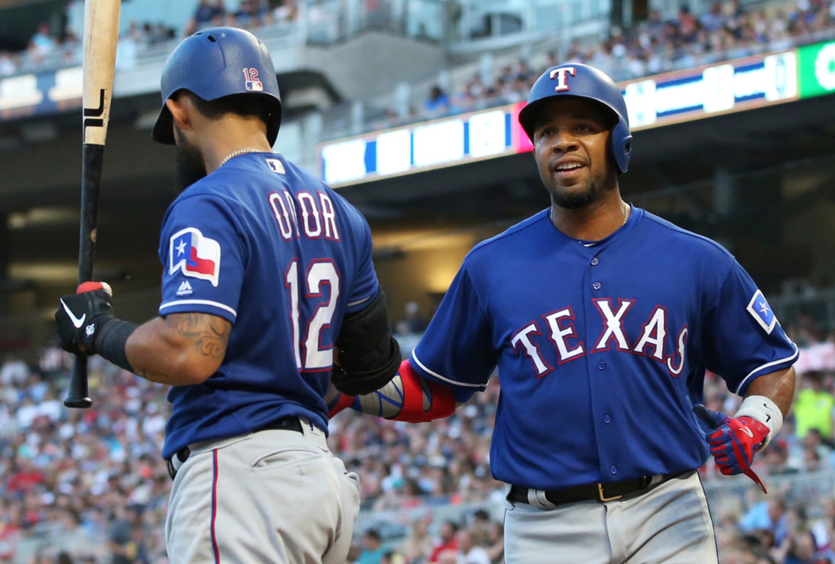 Texas Rangers' Elvis Andrus, right, is congratulated by Rougned Odor after Andrus scored on...