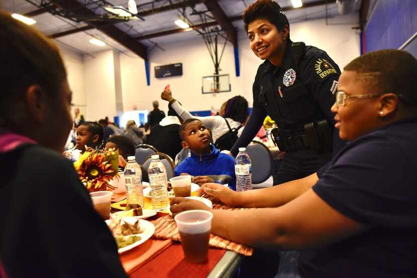 Police Officer Amber Roman visits with Jeremiah Robinson (left), 8, and Jaylen Massington,...