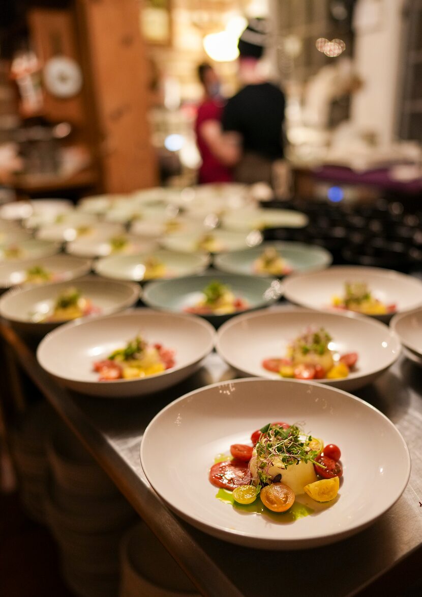 The first course of October tomatoes with a savory custard is readied for a special 'Autumn...