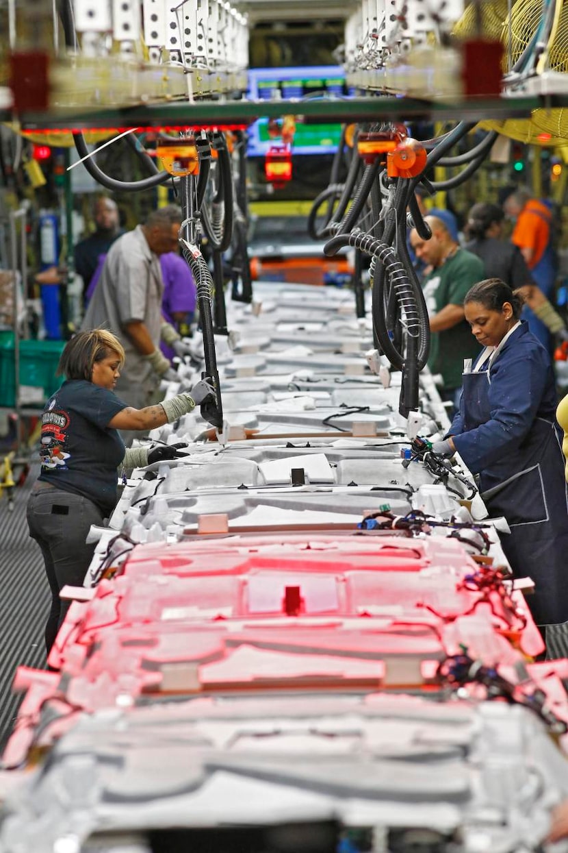 
Employees work on headliners at the GM plant in Arlington. Manager J.C. Jimenez says one of...