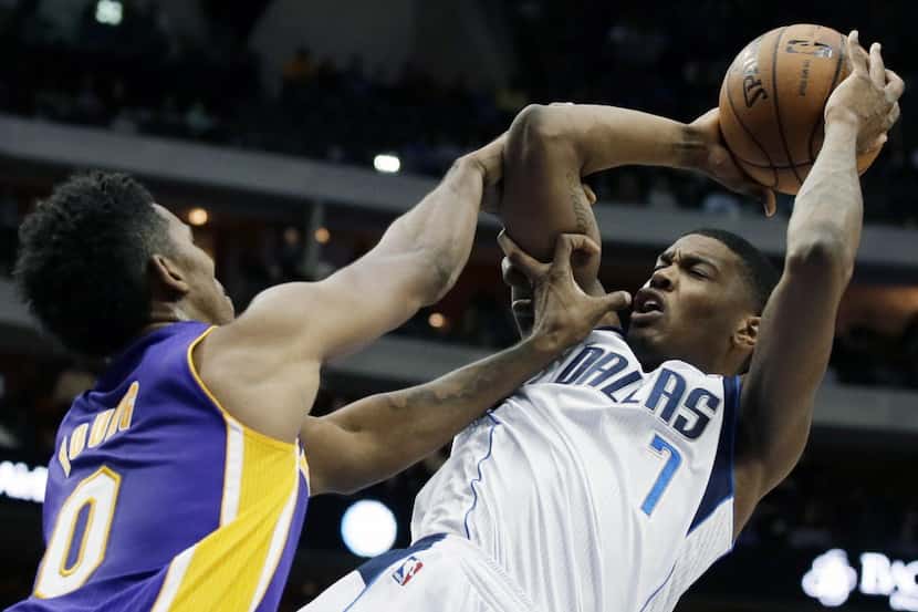 Los Angeles Lakers' Nick Young (0) fouls Dallas Mavericks' Ricky Ledo (7) on a shot attempt...