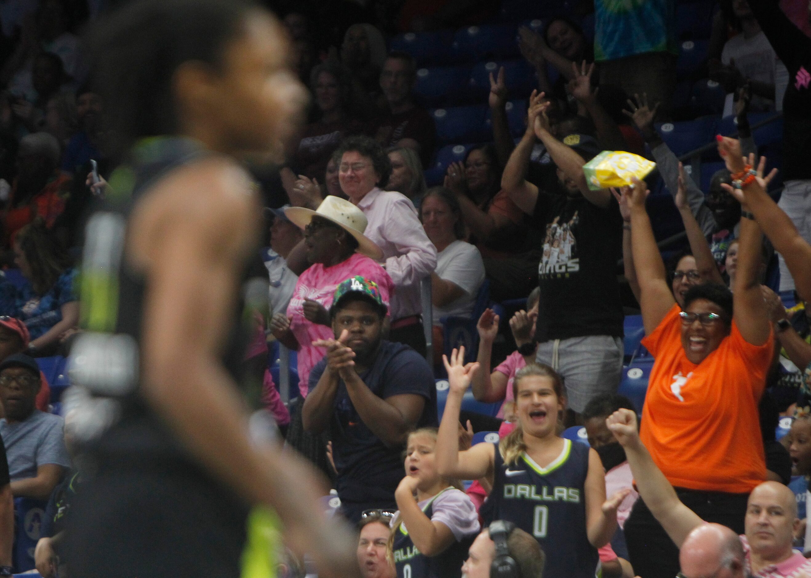 Dallas Wings fans erupt after Wings guard Crystal Dangerfield (11) sunk a 3-pointer during...