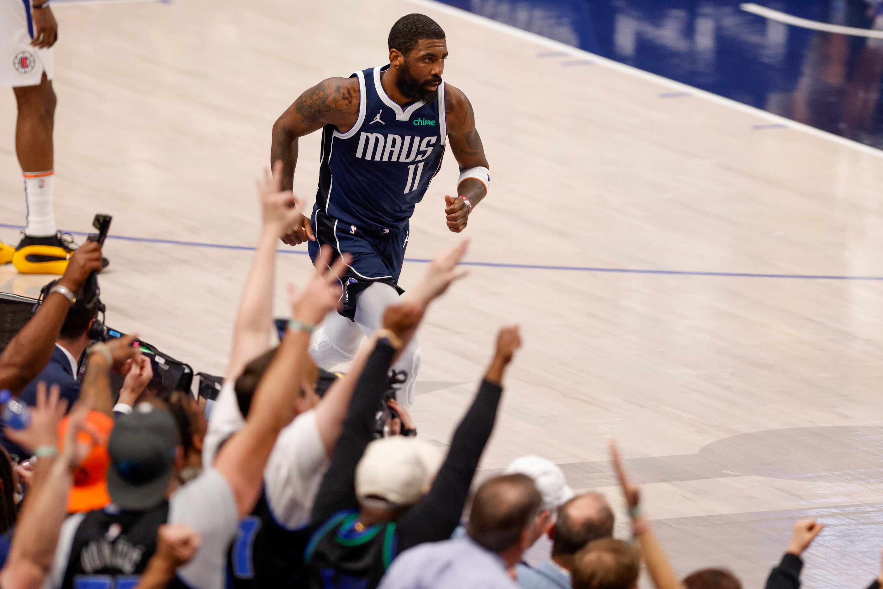 Fans cheer after a three-pointer by Dallas Mavericks guard Kyrie Irving (11) during the...