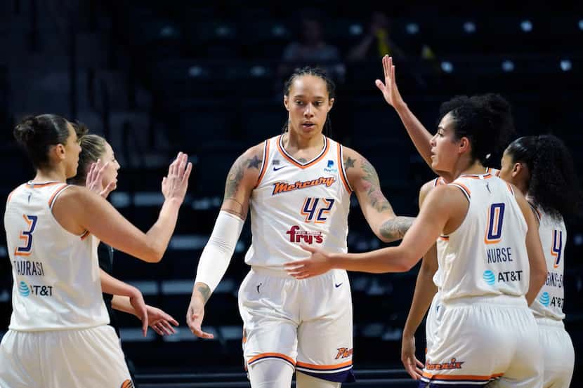 FILE - Phoenix Mercury's Brittney Griner (42) is congratulated on a play against the Seattle...