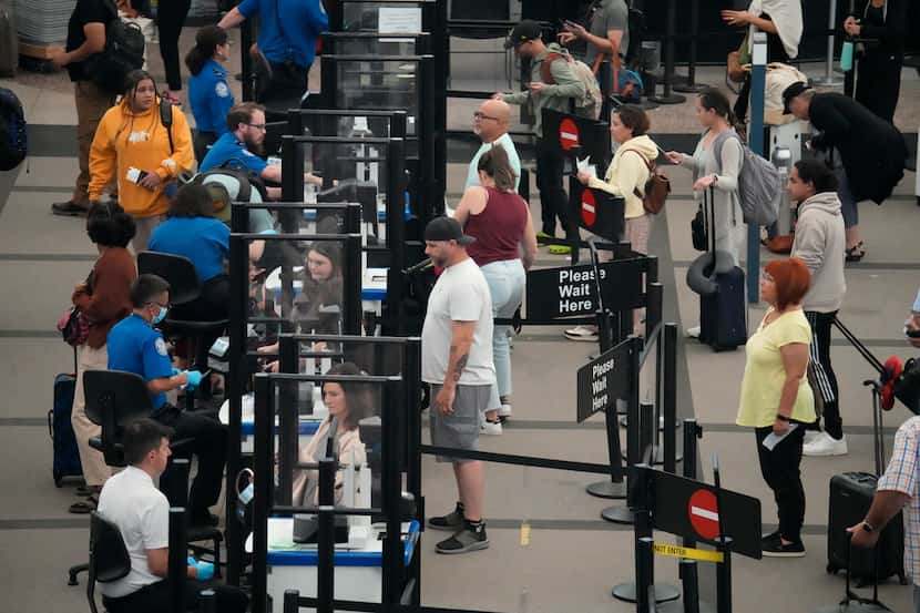 Passengers queue up at a Denver International Airport security checkpoint Sept. 1, 2023.