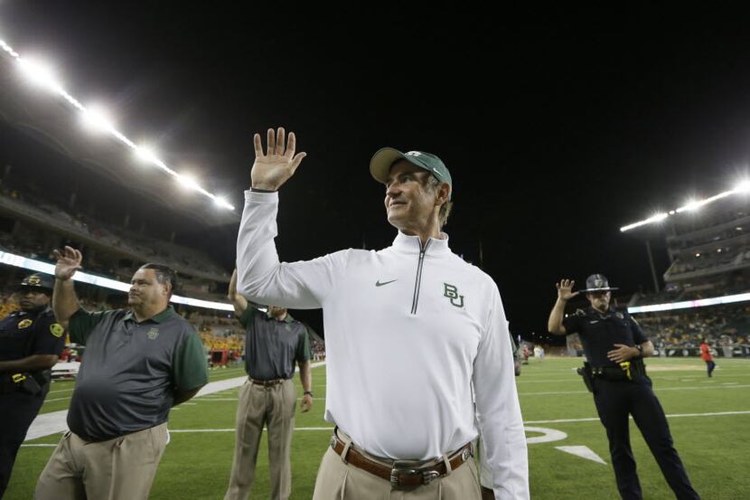 Baylor head coach Art Briles gestures as the school's song is played after an NCAA college...