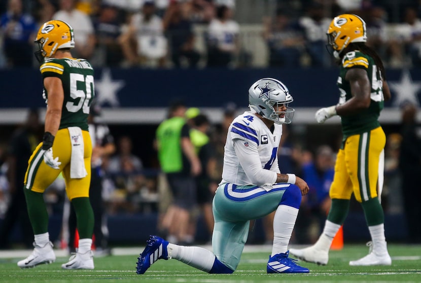 Dallas Cowboys quarterback Dak Prescott (4) gets up to walk back to the sideline after...