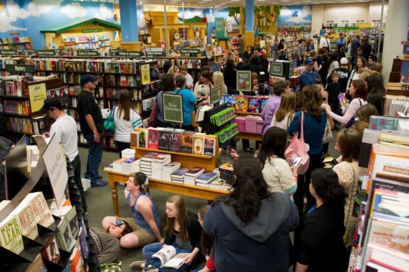 Fans wait for author Stephenie Meyer and cast members of "The Host" to arrive at the Barnes...