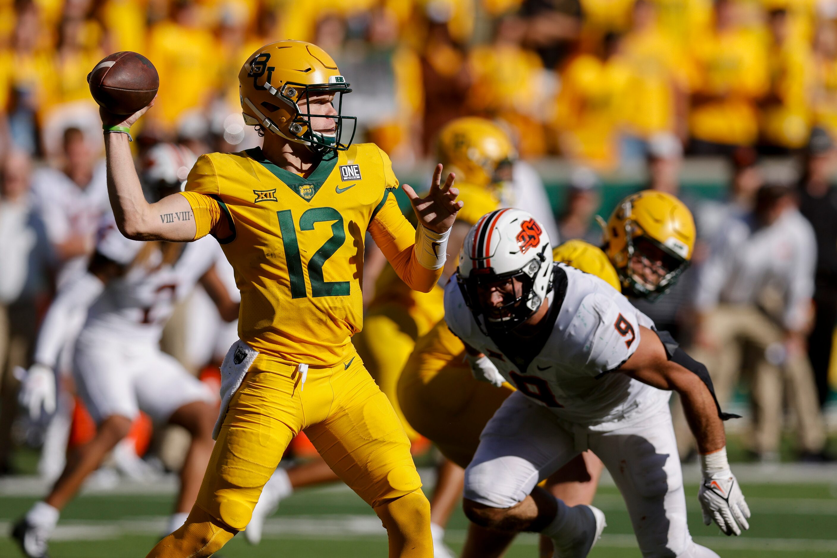 Baylor quarterback Blake Shapen (12) throws a pass under pressure from Oklahoma State...