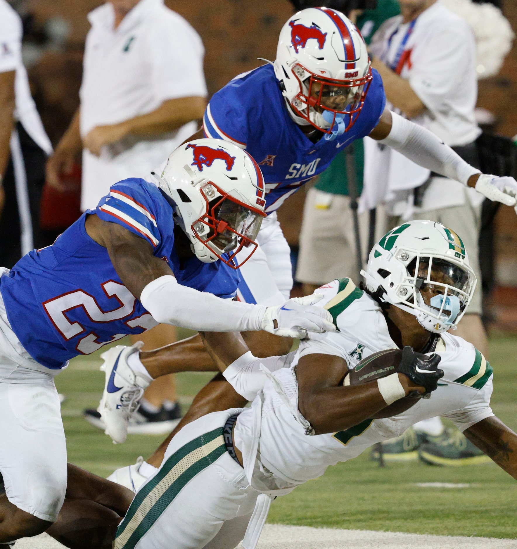 SMU safety Isaiah Nwokobia (23), left, SMU cornerback Chris Megginson (12), center, go to...