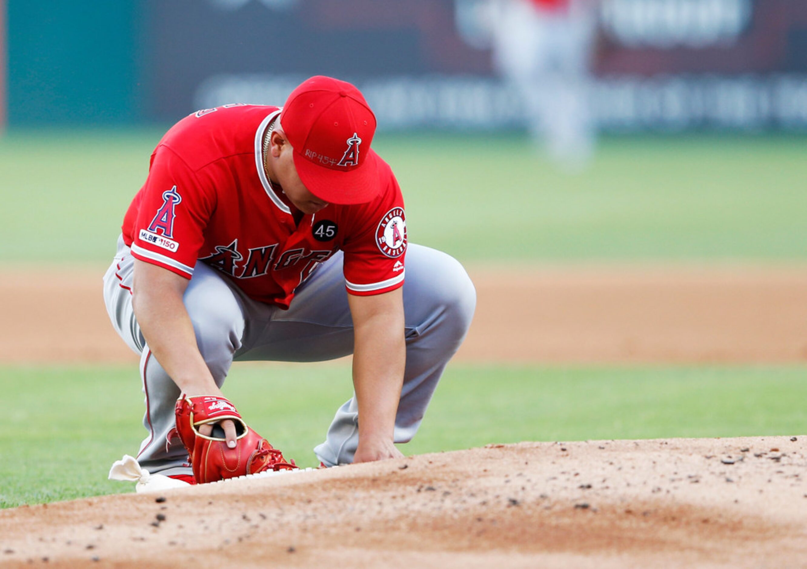 Los Angeles Angels starting pitcher Jose Suarez (54) pauses at the back of the mound where...