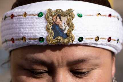 Nancy Sanchez wears a headband with an image of “Madonna and Child” outside the Earle Cabell...