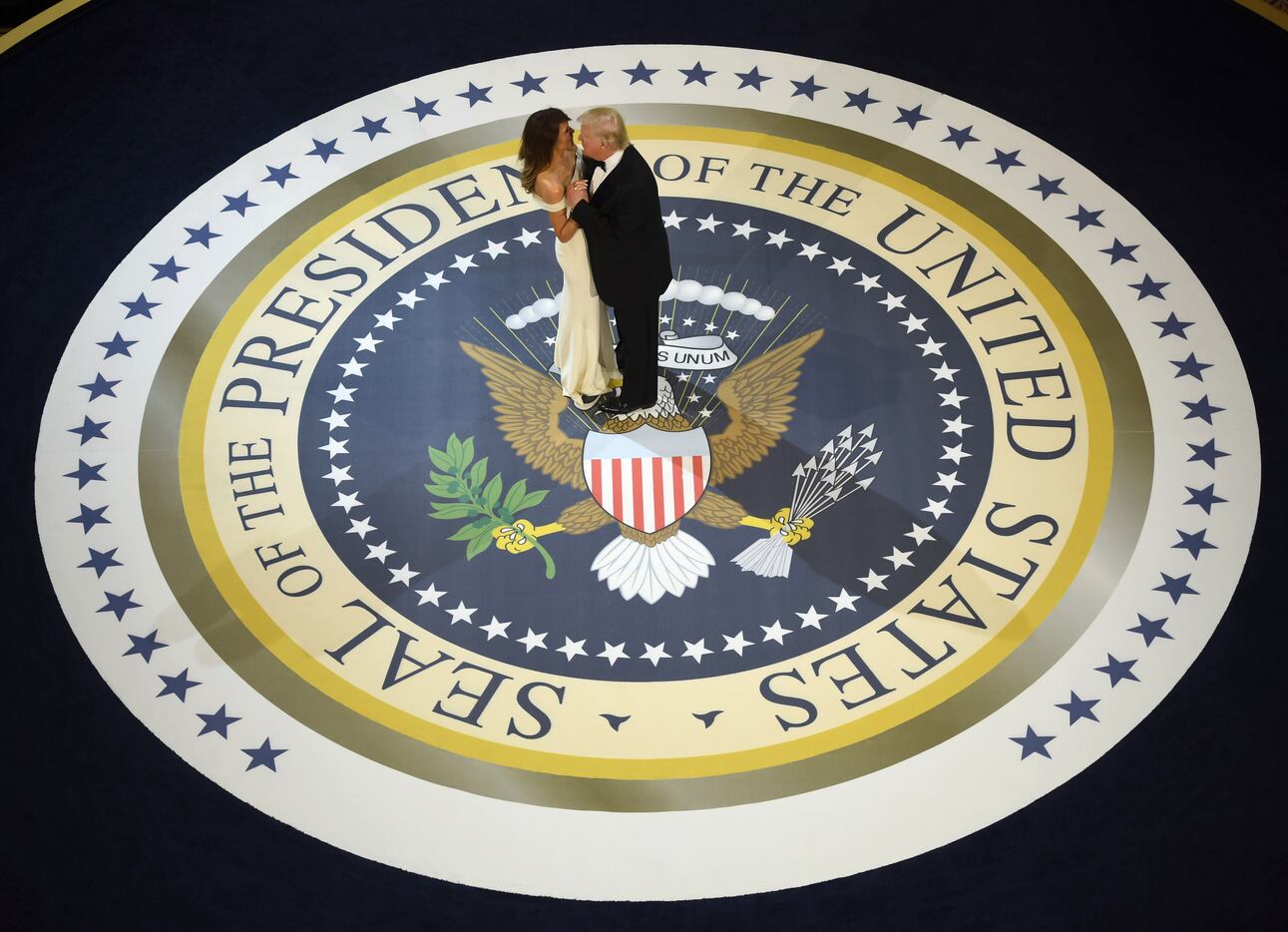 President Donald Trump and the first lady Melania Trump dance at the Armed Services ball at...