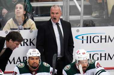 Minnesota Wild head coach Dean Evason, center, gives instructions during the first period of...