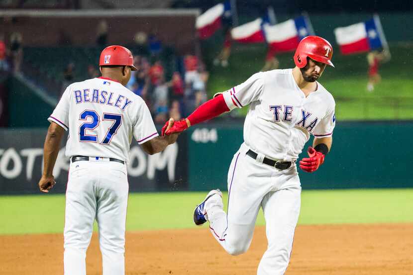 Texas Rangers third baseman Joey Gallo (13) shakes hands with third base coach Tony Beasley...