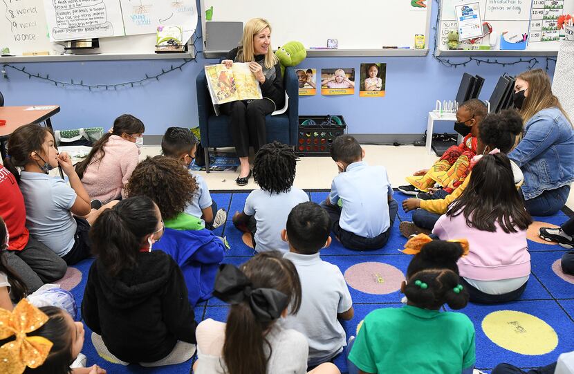 Michelle Vopni, Dallas office managing partner of Ernst & Young LLP, reads to local students...