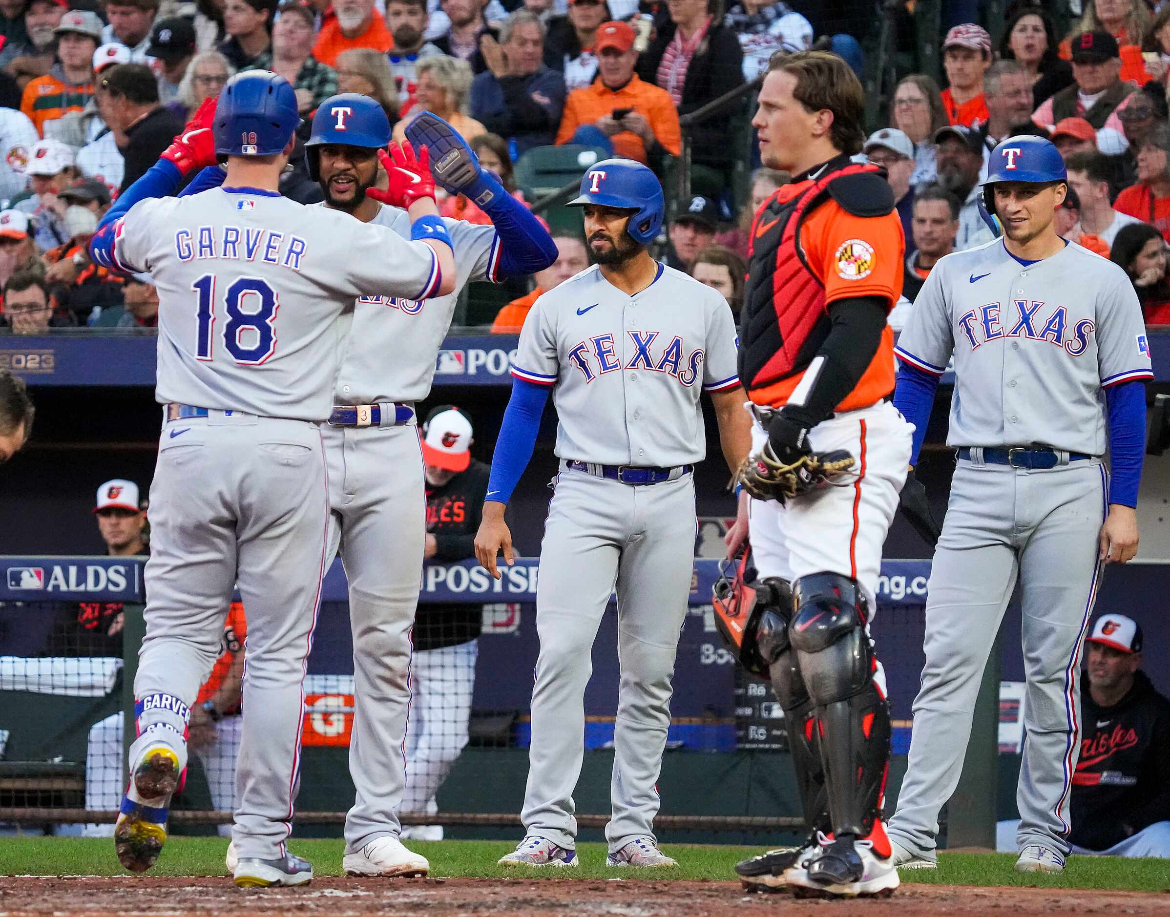 Texas Rangers designated hitter Mitch Garver celebrates with center fielder Leody Taveras,...