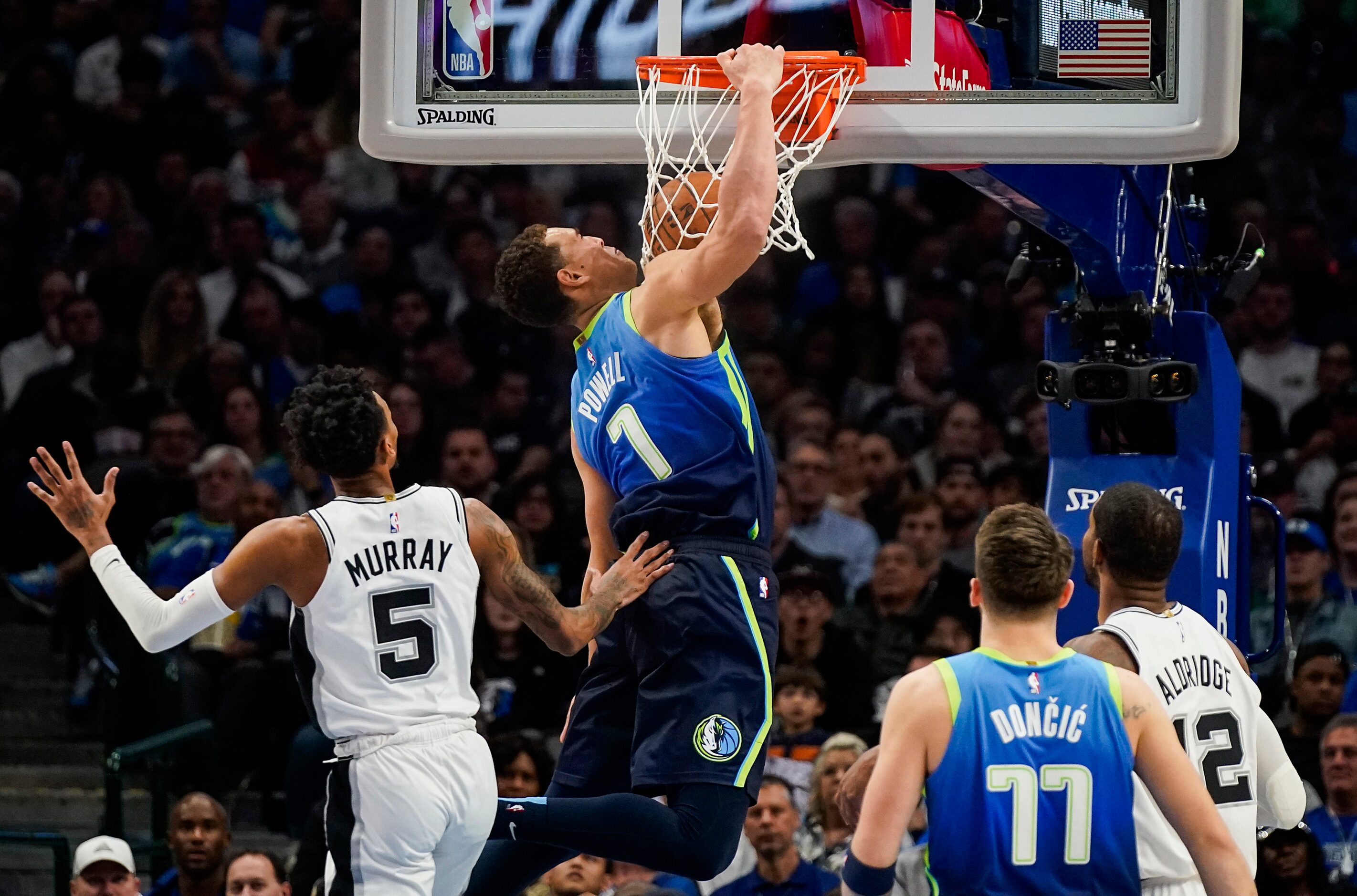 Dallas Mavericks forward Dwight Powell (7) dunks the ball past San Antonio Spurs guard...