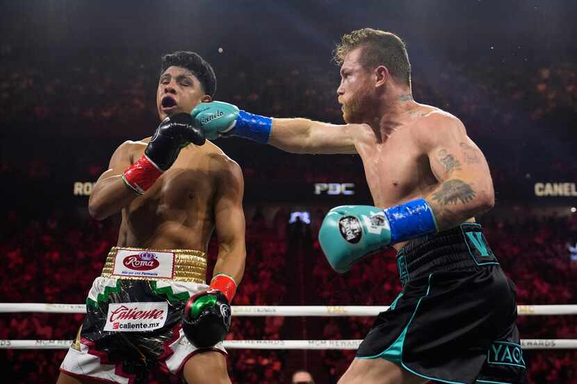 Canelo Alvarez hits Jaime Munguia in a super middleweight title fight Saturday, May 4, 2024,...