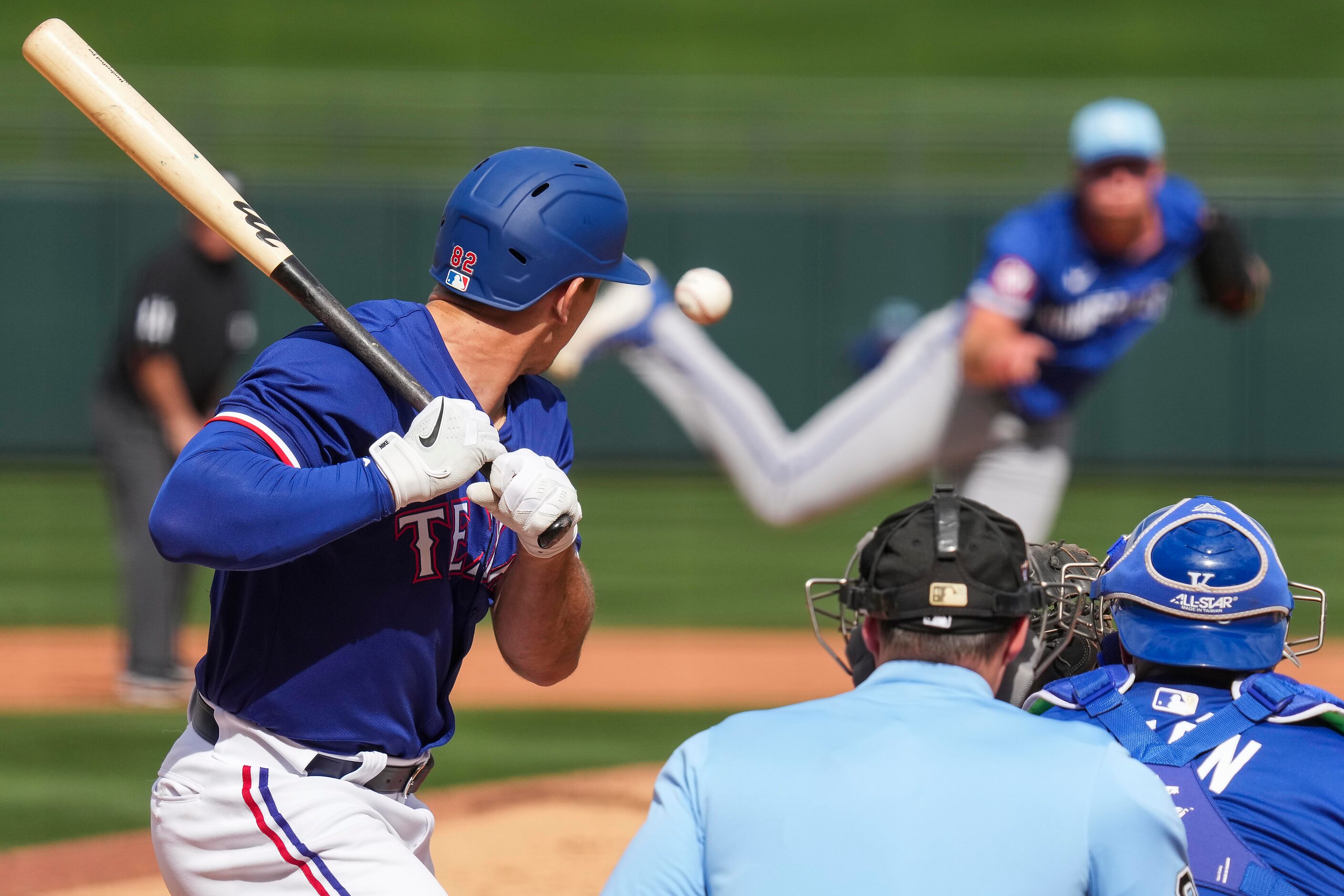 Texas Rangers outfielder Wyatt Langford backs away from an inside pitch by Kansas City...