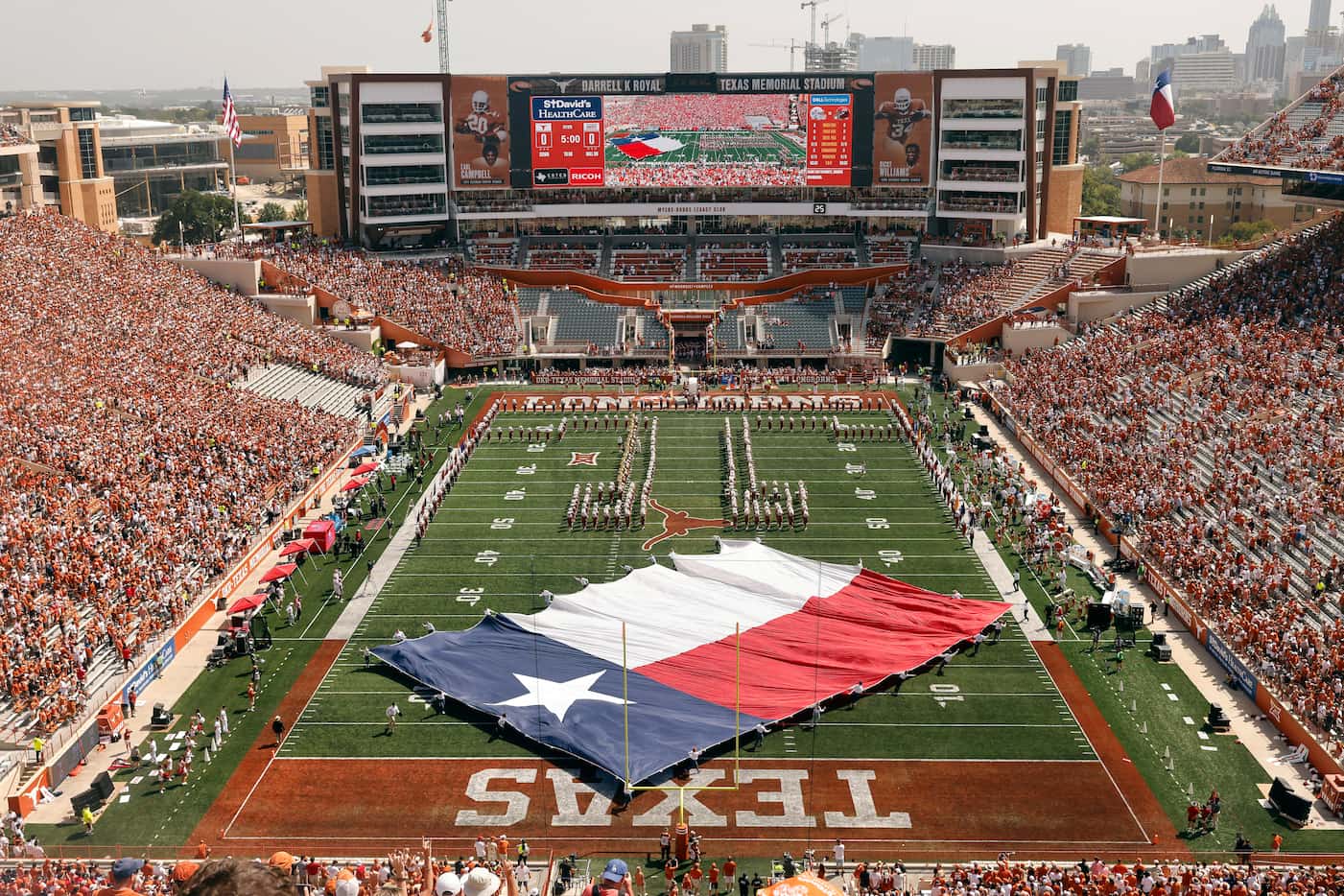 The Texas flag is spun around on the DKR-Texas Memorial Stadium before kickoff in Austin,...