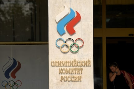 A woman walks out of the Russian Olympic Committee building. Her nation breathed a sigh of...