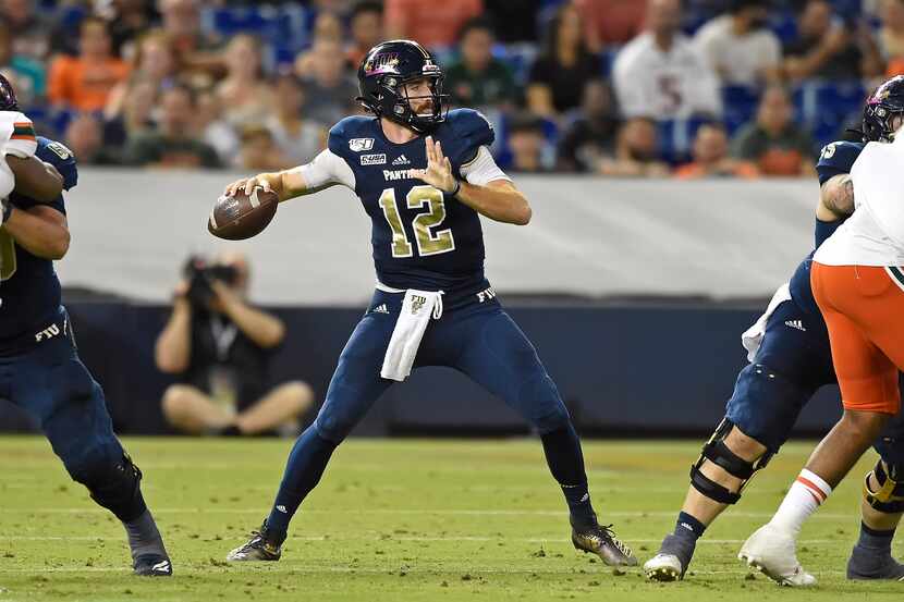 MIAMI, FL - NOVEMBER 23:  FIU quarterback James Morgan (12) passes in the third quarter as...
