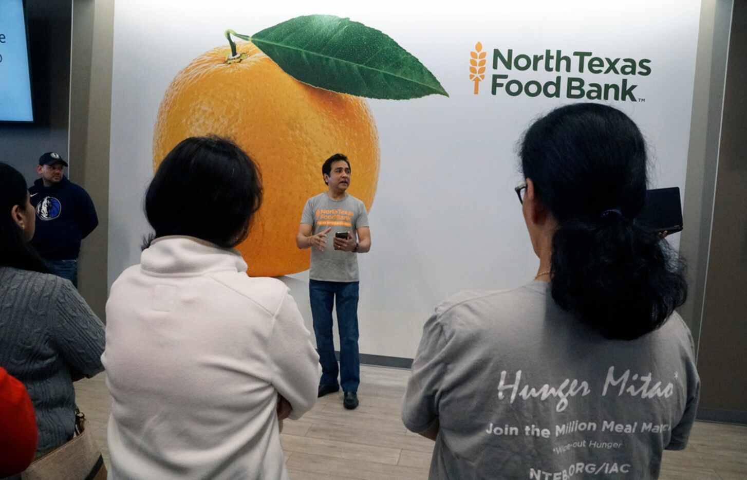 Raj Asava speaks to more than 100 volunteers at North Texas Food Bank in Plano. (Lawrence...