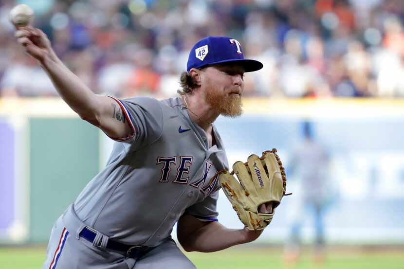 Texas Rangers starting pitcher Jon Gray throws to a Houston Astros batter during the first...