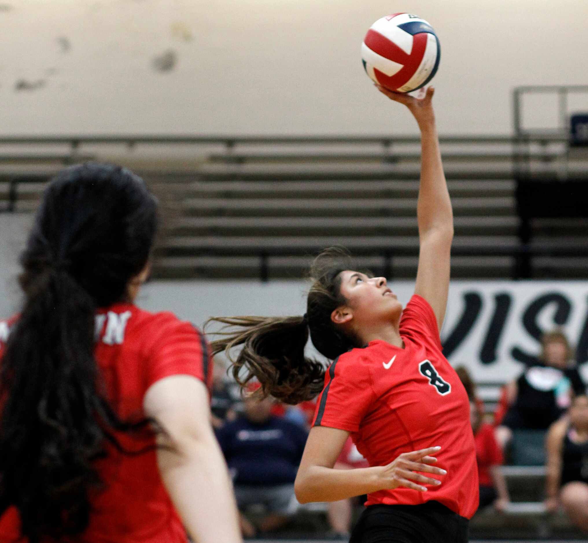 Arlington Martin's Emily Mijares (8) returns the ball during the second set of their match...