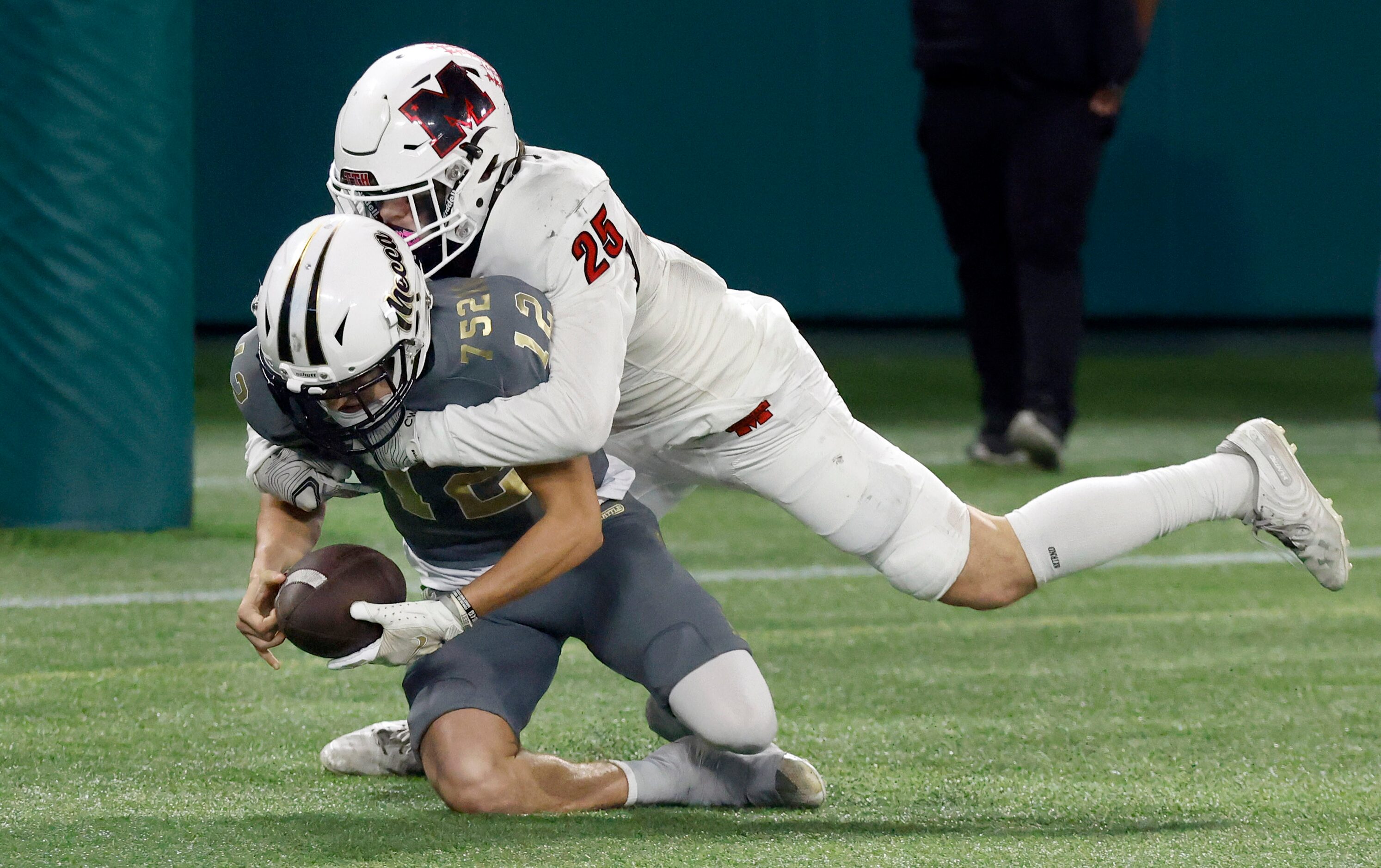 South Oak Cliff punter Carter Koepcky (12) is tackled in the end zone by Melissa Landen...