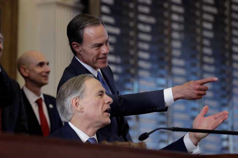 Texas Gov. Greg Abbott, front, and Texas Speaker of the House Joe Straus, R-San Antonio,...