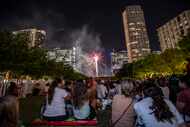 Fireworks light up the skyscrapers of downtown and uptown during a fourth of July...