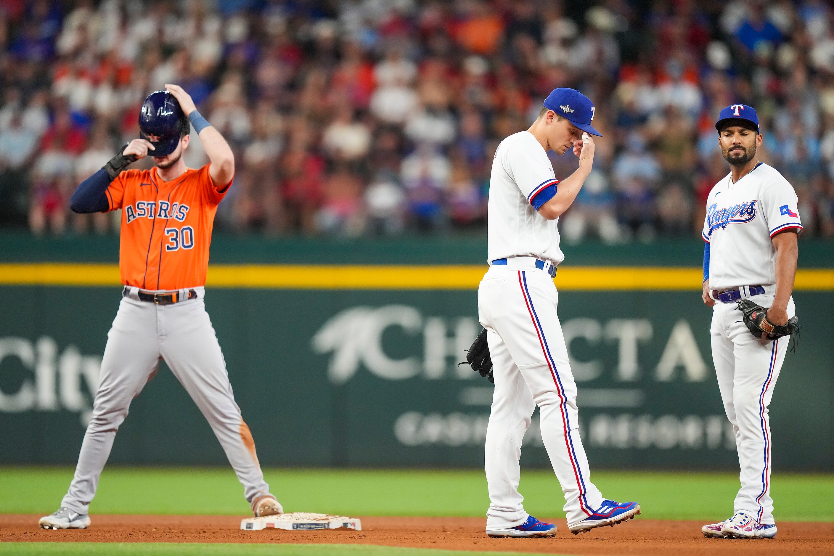 Texas Rangers shortstop Corey Seager (5) and second baseman Marcus Semien (2) react after an...