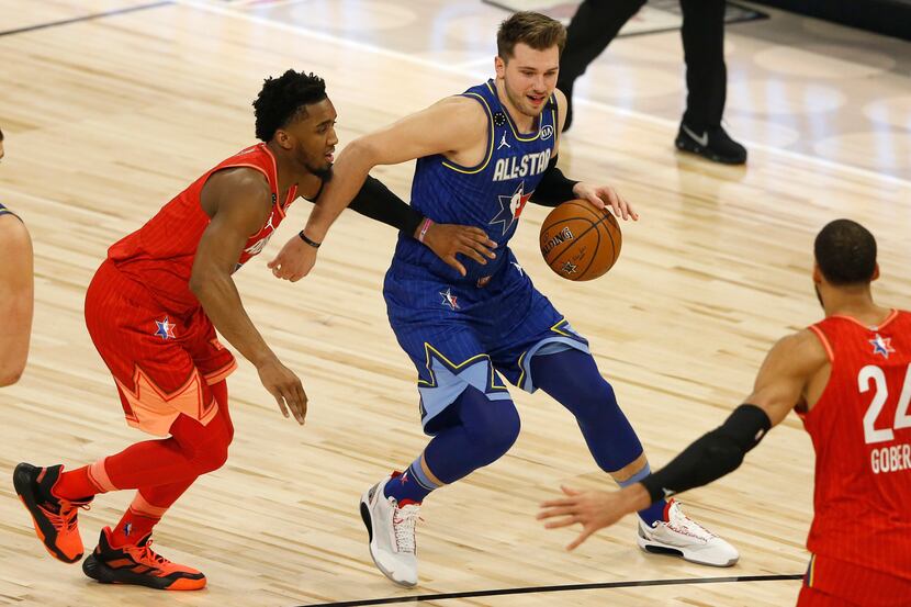 Team LeBron's Luka Doncic (2) dribbles past Team Giannis's Donovan Mitchell (24) toward Rudy...