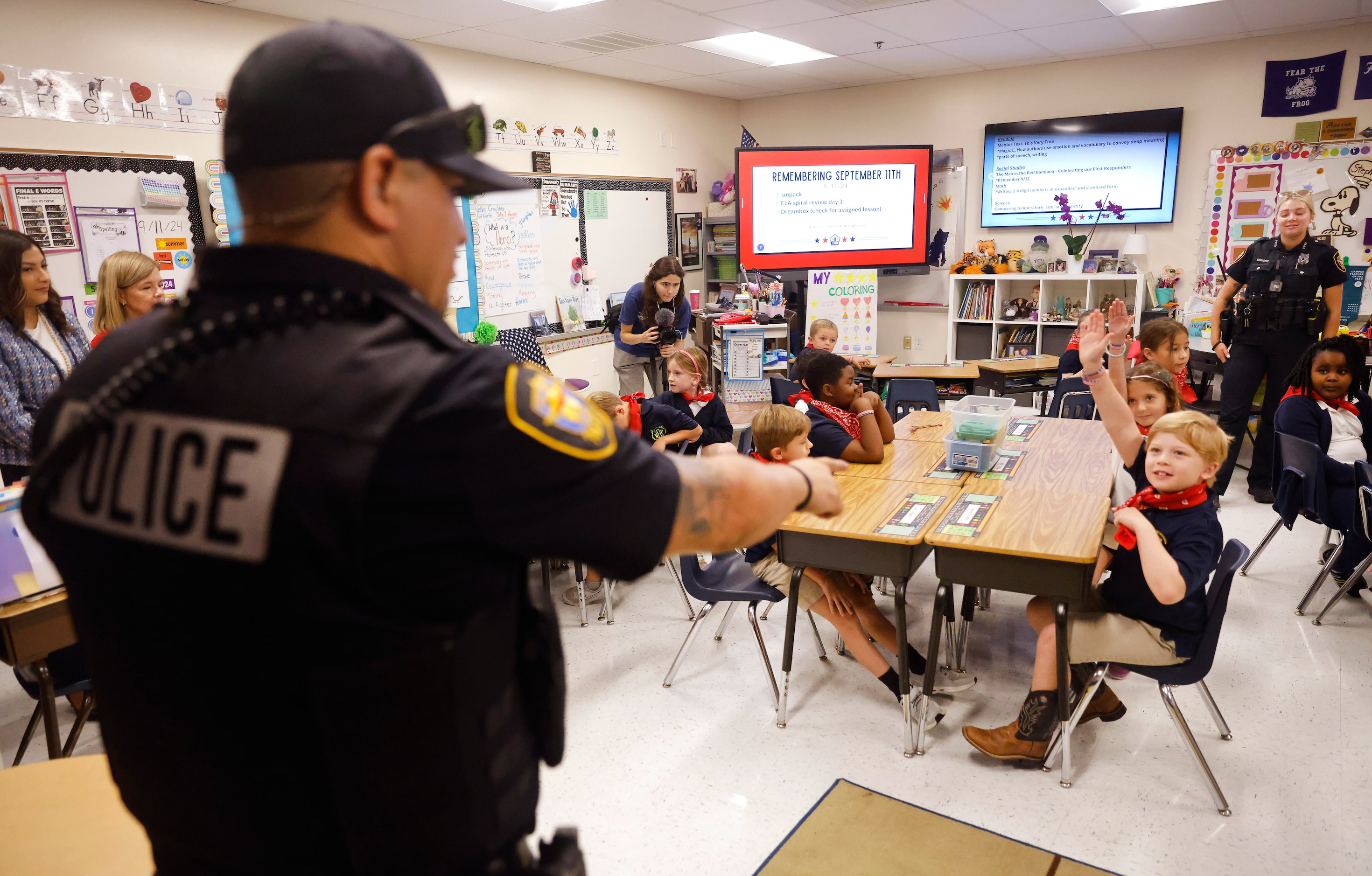 Fort Worth Police officer Noel Limon calls on second grader Tucker Dubinsky to answer a...