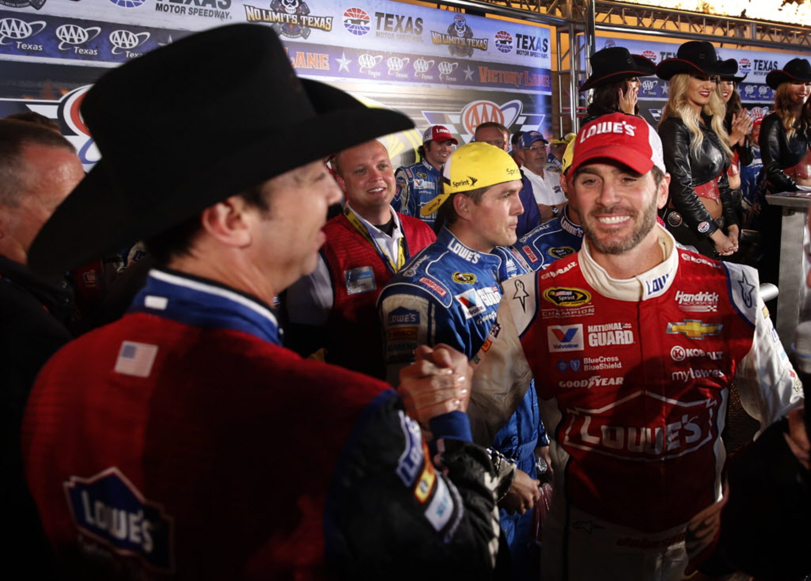 Sprint Cup Series driver Jimmie Johnson, right, celebrates his AAA Texas 500 win in Victory...