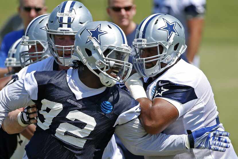 Dallas Cowboys offensive line Joe Looney (73) and center Jake Brendel (60) team up to block...
