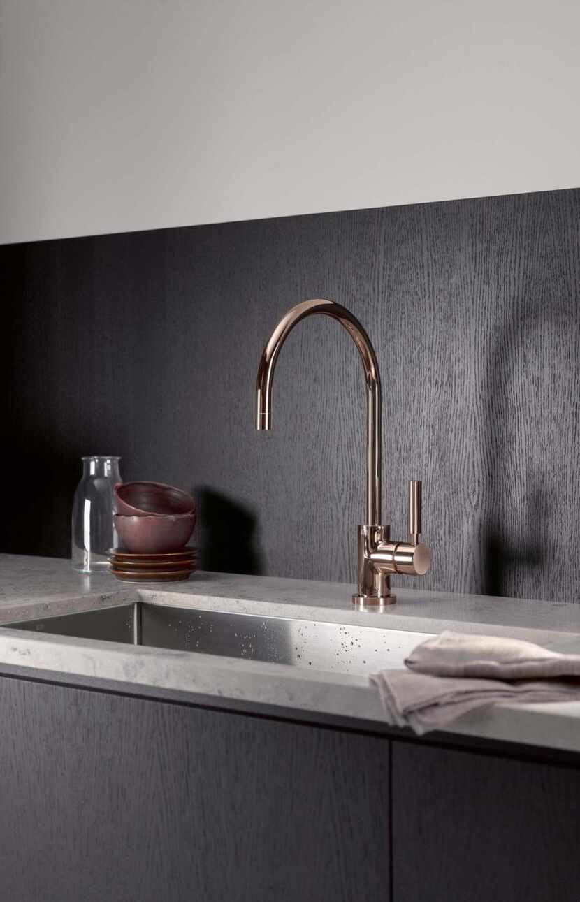 Beyond cabinet knobs and drawer pulls, consider golden-hued options for your faucet.