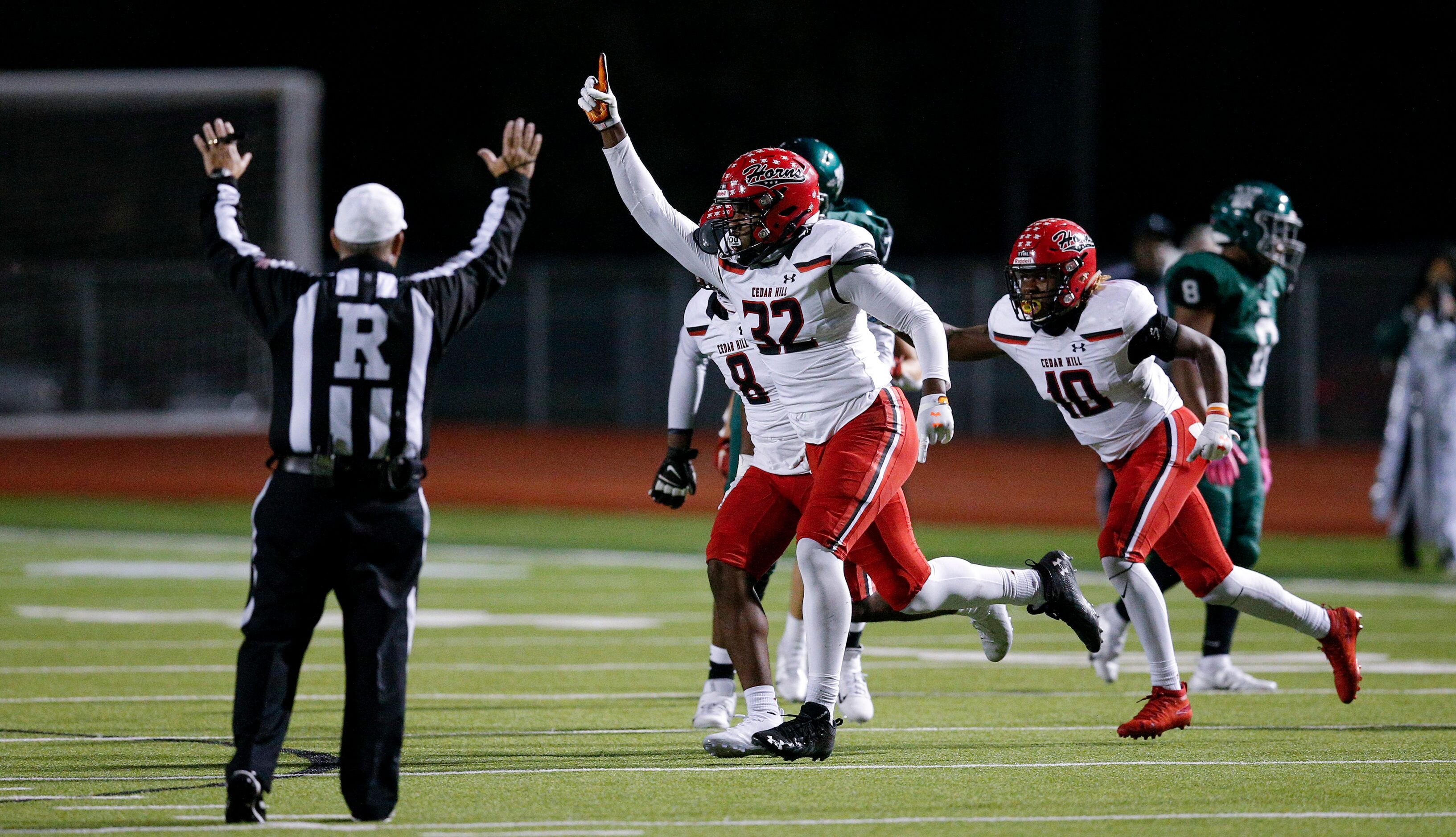 Cedar Hill senior defensive end Charles Esters III (32) celebrates the ball turning over on...