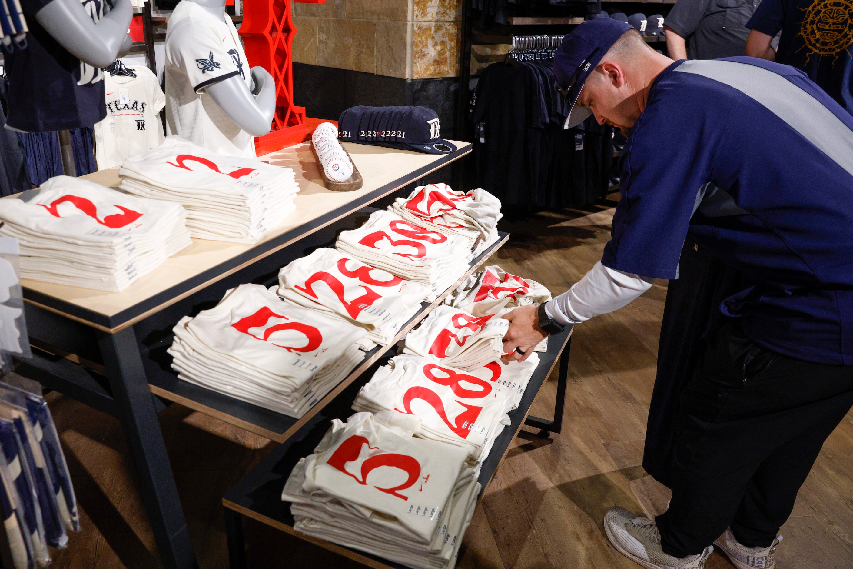 Taylor Rogers browses new Texas Rangers new City Connect shirts at Globe Life Field on...