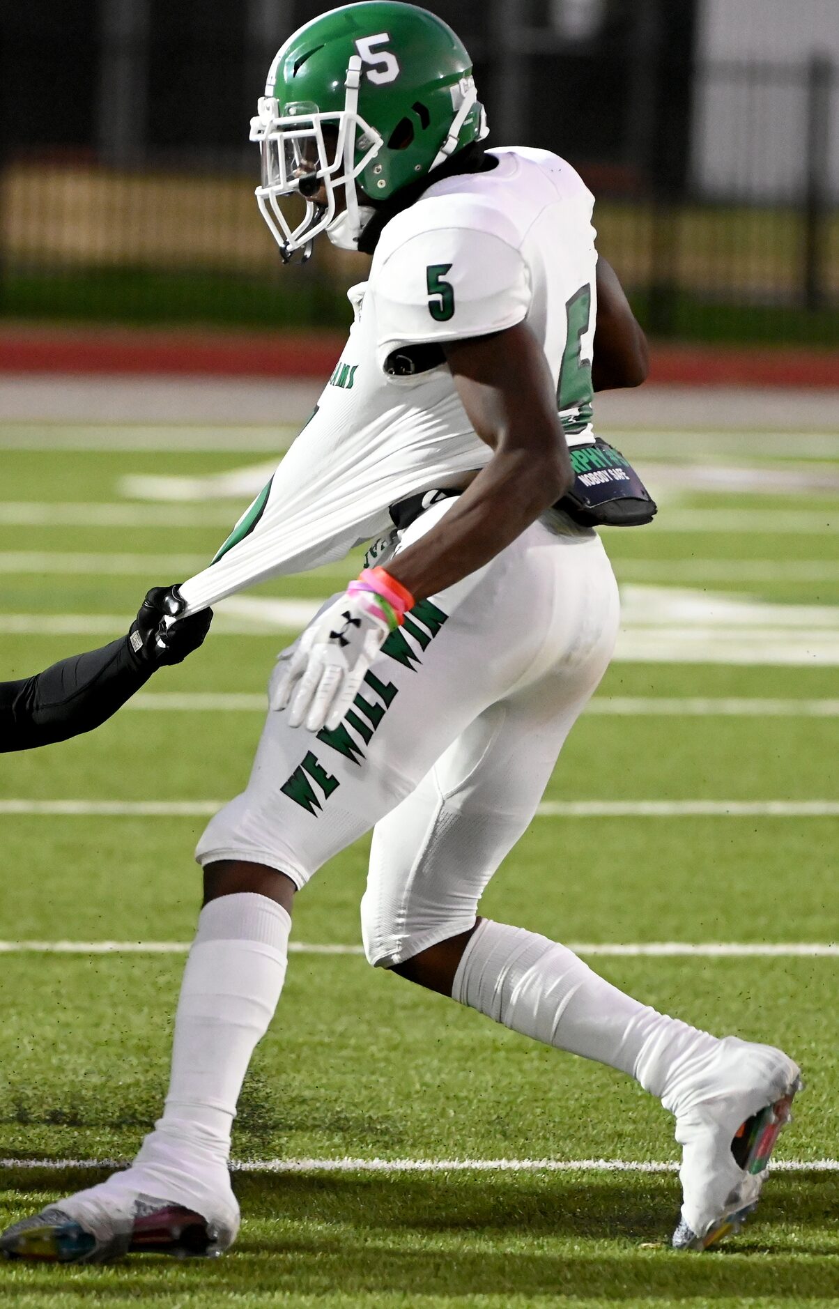 Bryan Adam’s Antoine Murphy (5) tries to get away from Lincoln’s Donnell Williams in the...