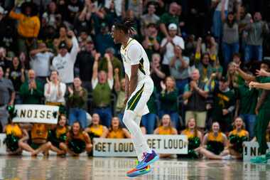 Baylor's Ja'Kobe Walter reacts after scoring a basket against Texas during the second half...