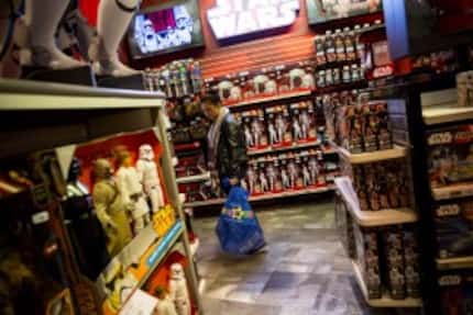  A shopper checks out Star Wars merchandise at the Toys R Us on Times Square in New York, on...