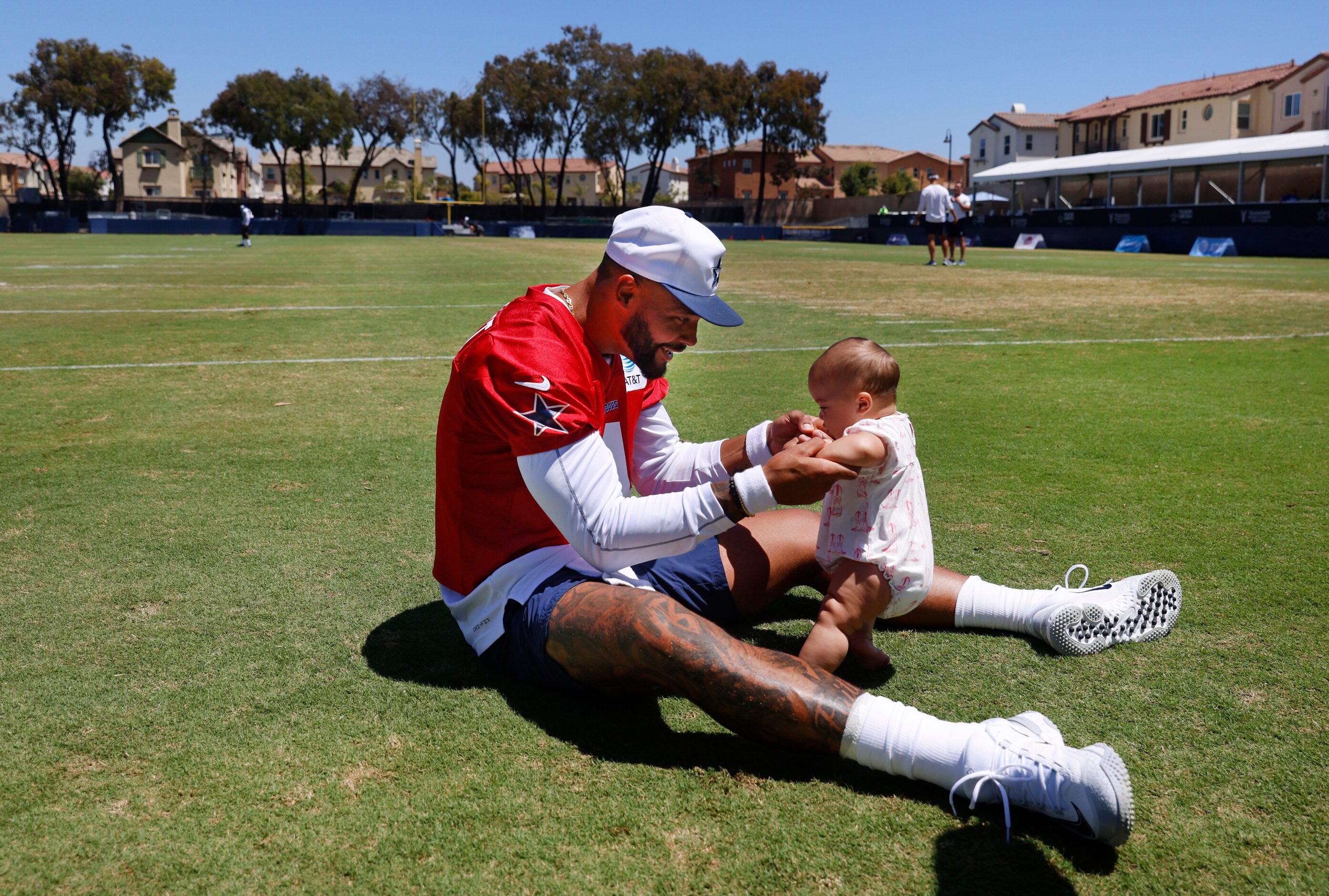 Dallas Cowboys quarterback Dak Prescott plays with his baby daughter Margaret Jane Rose...