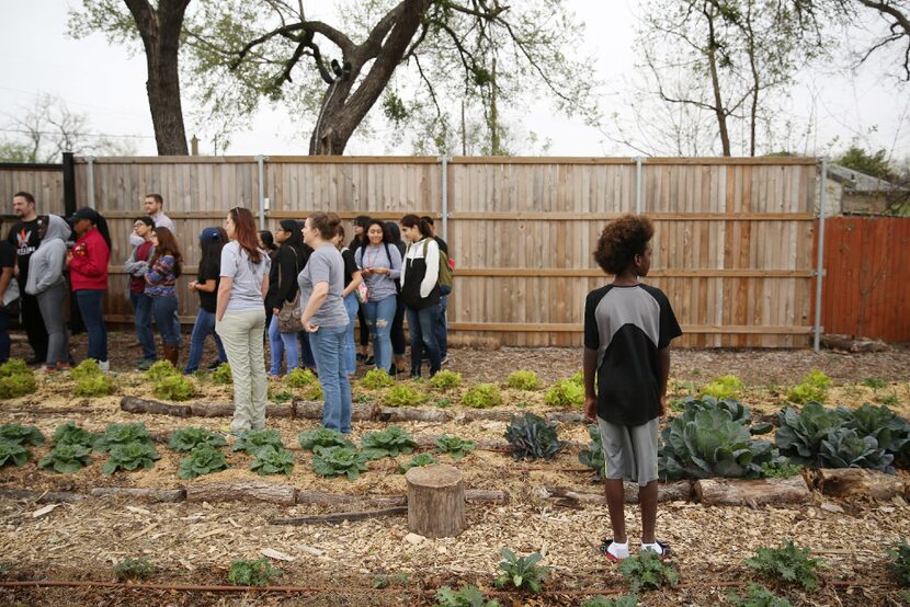 Mike (last name withheld), 11, right, joins a tour hosted by farm manager Patrick Wright for...